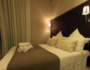 Postel nebo postele na pokoji v ubytování Hotel Felice