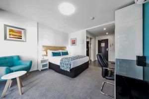 a hotel room with a bed and a tv at Pegasus Apart-Hotel in Melbourne