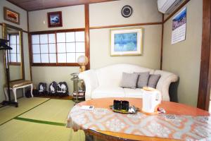 a living room with a couch and a table at Oasis Minamiyukigaya in Tokyo