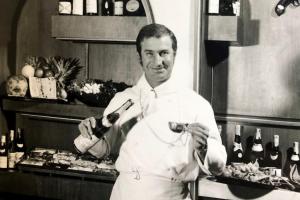 a man in a kitchen holding a bottle of wine at Hotel Las Palmas in San Felipe