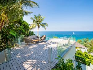an outdoor deck with a view of the ocean at Villa Borimas by Elite Havens in Surin Beach