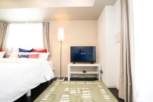 Un pat sau paturi într-o cameră la Hotel Central Yokohama