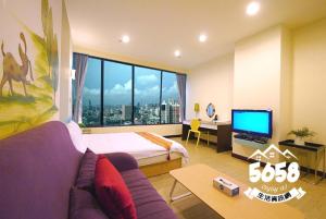 a hotel room with a bed and a couch at 85 Vacation ApartHotel in Kaohsiung