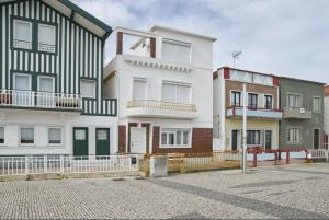 a group of buildings in a parking lot at Captain Pisco's Palheiro - Great Location in Costa Nova
