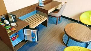 a toy kitchen with a desk and a refrigerator at Hotel Omni Residency Dhaka in Dhaka