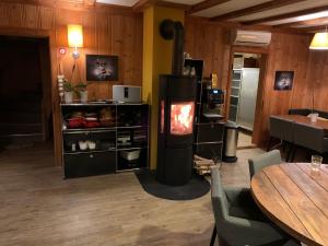 a living room with a fireplace and a table at AmdenLodge - Berg Chalet in Amden am Walenssee - Event, Seminar, Ferienlager in Amden