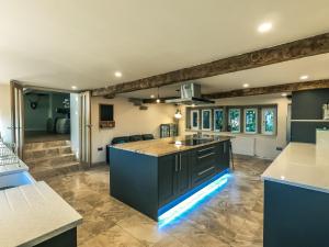 a kitchen with blue cabinets and a counter top at Luxury traditional stone farmhouse in Saddleworth in Oldham