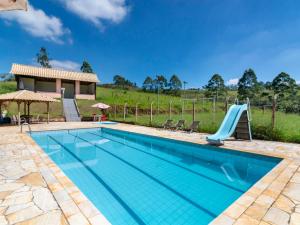 a swimming pool with a slide in a villa at Hotel Fazenda Morada Do Imperador in Barbacena