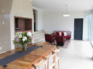 a living room with a table and a fireplace at 401 Rozendal Cottages in Stellenbosch