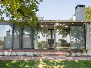 a glass house with a lot of windows at 401 Rozendal Cottages in Stellenbosch