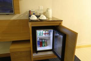 a small refrigerator with drinks in a hotel room at Ciao SaiGon Hotel & Spa in Ho Chi Minh City