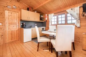a kitchen and dining room with a table and chairs at Sireksstadir Farm Holiday in Vopnafjörður