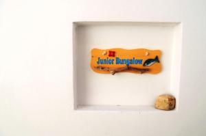a sign on a white door with a rock at Summer Residence in Provatas