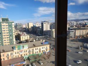 a view from a window of a city with buildings at K Hostel in Ulaanbaatar