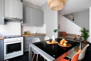 a kitchen with a table and a dining room at Sapore di Sori New Apartment in Sori