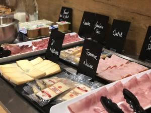 a buffet with cheese and meats and other foods at Kyriad Aix Les Milles - Plan de Campagne in Bouc-Bel-Air