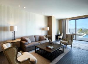 a living room with a couch and chairs and a table at Pelagos Suites Hotel & Spa in Kos
