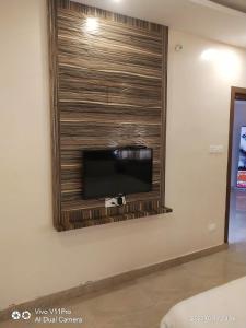 a flat screen tv on a wall in a room at Sri Kamadhenu Residency in Coimbatore
