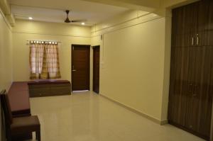 an empty hallway with a door and a window at MS HOMESTAY in Port Blair