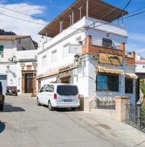 a white van parked in front of a building at Hostal Valle Del Sol Alora in Alora