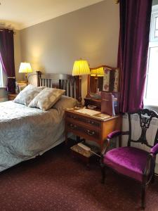 Brookvale في Wellingtonbridge: غرفة نوم بسرير ومكتب وكرسي
