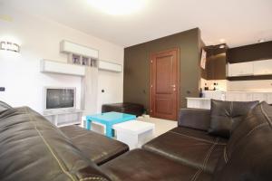 a living room with a couch and a tv at Trendy & Deluxe Apartment in Plovdiv