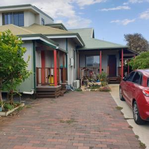 a house with a red car parked in front of it at Bunbury's Most Convenient Location in Bunbury