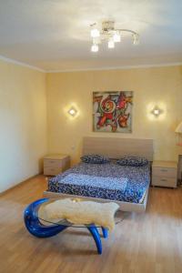 a bedroom with a bed and a surfboard on the floor at Apartment Triokhsviatytelskaya Street 3 in Kyiv