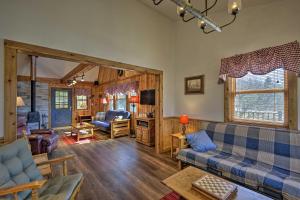 a living room with a couch and a table at Springwater Cabin Near Hiking, Lakes, and Vineyards in Springwater