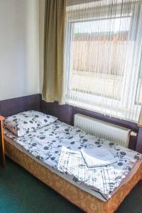 Łóżko lub łóżka w pokoju w obiekcie Pokoje Hotelowe Norbit