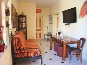 普拉坦亞斯的住宿－Villa Eleni Seaside Apartments，客厅配有桌子和电视