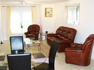 a living room with leather furniture and a table at Hidden Gem in Manchester