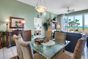 a living room with a glass table and a couch at TOPS'L Tides I in Destin