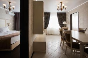 a hotel room with a bed and a dining room at Vladykino Apart-Hotel in Moscow