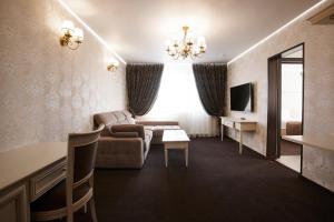 a living room filled with furniture and a tv at Vladykino Apart-Hotel in Moscow