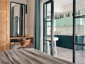 a bedroom with a bed and a bathroom with a sink at Bella Vista Building A - 100m from Solomos Square, by ZanteWize in Zakynthos Town