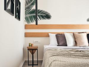 a bedroom with a bed and a side table at Bella Vista Building A - 100m from Solomos Square, by ZanteWize in Zakynthos Town +15 photos