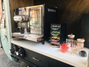 a counter with a coffee maker on top of it at Hotel Perte at Montecasino in Johannesburg