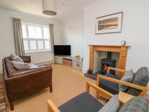a living room with a couch and a fireplace at Craigluscar in Newport Pembrokeshire
