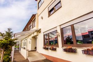 a building with windows and potted plants on it at Hotel Bohn in Metzingen