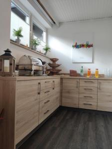 a kitchen with wooden cabinets and a counter top at Hotel Novostar in Kassel