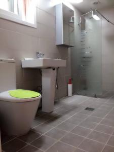a bathroom with a toilet and a sink and a shower at Kbook9 guesthouse in Seoul