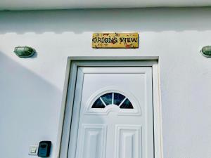 a sign above a white door with a sign above it at Sounio Golden View Villas in Sounio
