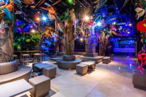 a room with trees and stools and lights at Hotel Black Tower Premium in Bogotá