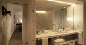 a bathroom with a sink and a mirror at Lisboa Pessoa Hotel in Lisbon