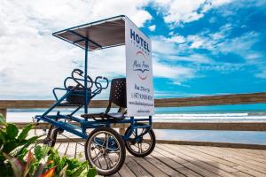 a stand for a beach party on a boardwalk at Hotel Itapema Meia Praia in Itapema