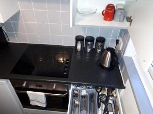 a kitchen with a stove top oven in a kitchen at The Willows in Crawley +7 photos