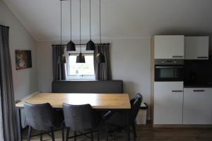 a kitchen with a dining room table and chairs at De Bijsselse Enk, Noors chalet 1 in Nunspeet