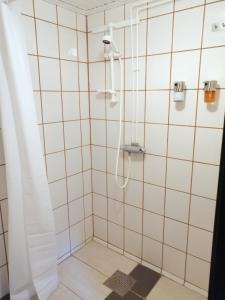 a shower with a shower curtain in a bathroom at 4Stay Vislanda Sauna in Vislanda +21 photos