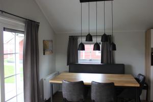 a dining room with a wooden table and chairs at De Bijsselse Enk, Noors chalet 5 in Nunspeet